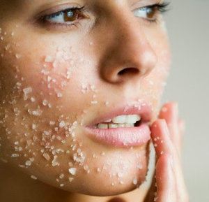 scrub exfoliant on woman's face
